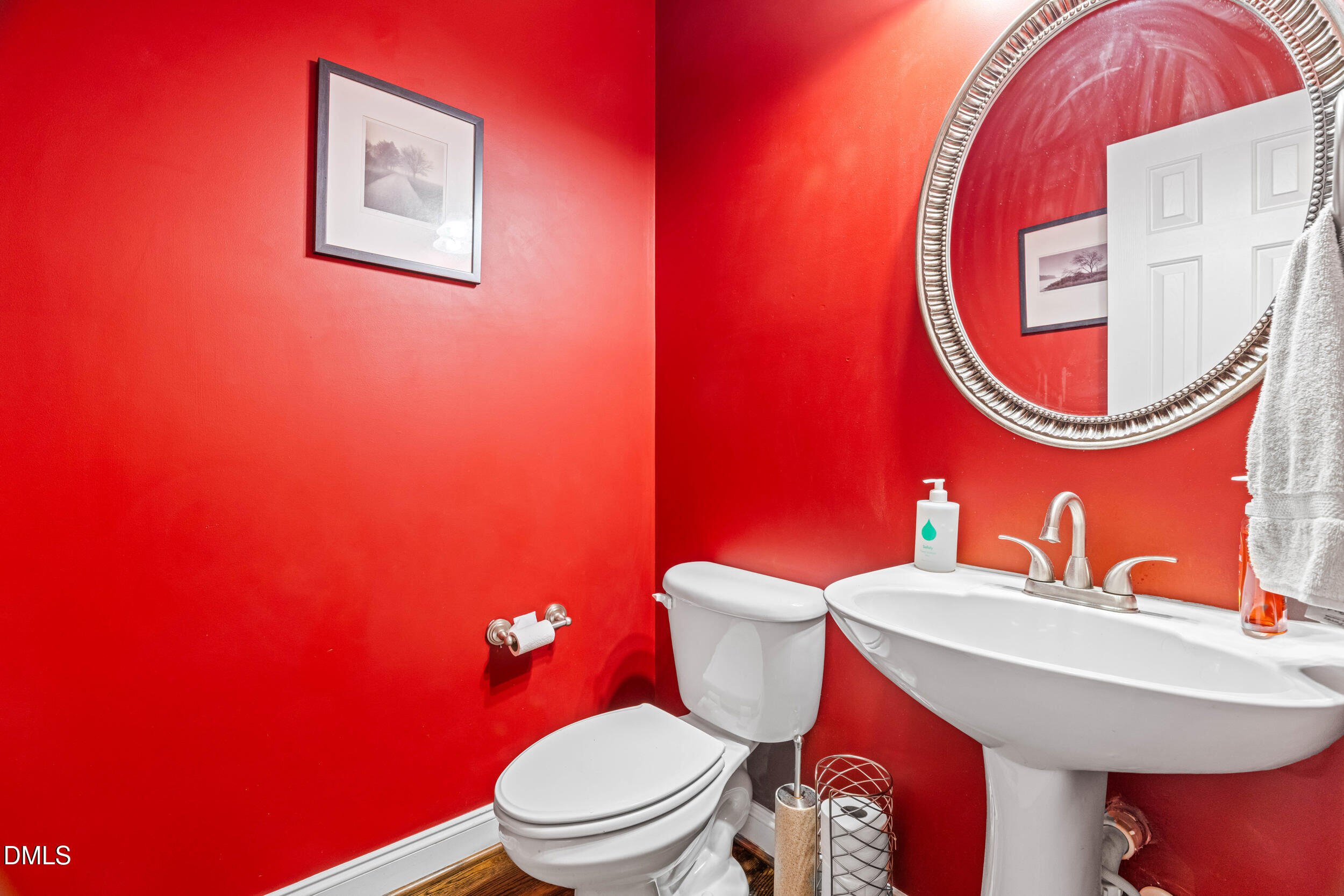 126 Geranium Way Clayton, NC 27527 - Photo 17 of 35 a bathroom with a toilet a sink and a mirror
