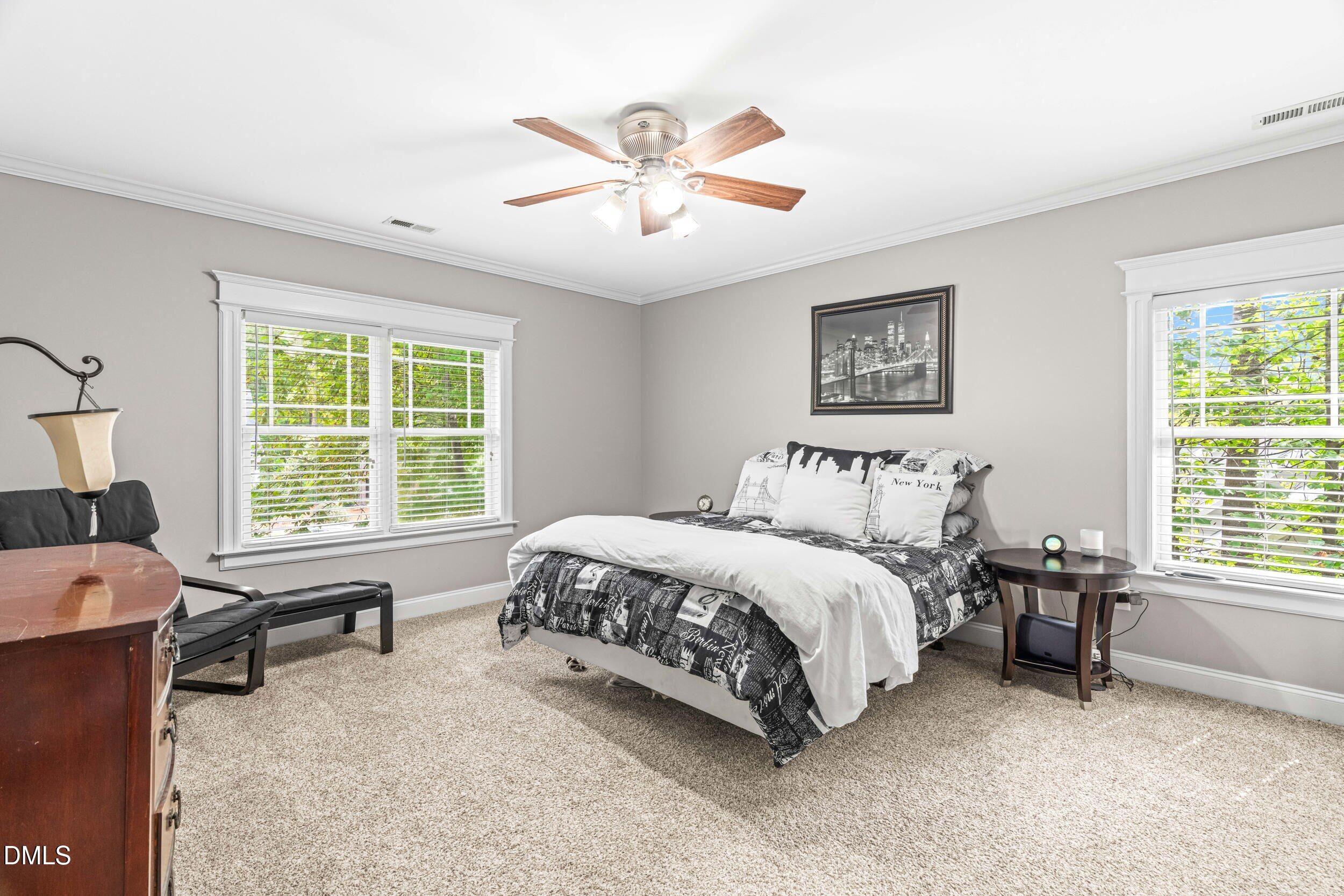 126 Geranium Way Clayton, NC 27527 - Photo 19 of 35 a spacious bedroom with a bed and a window