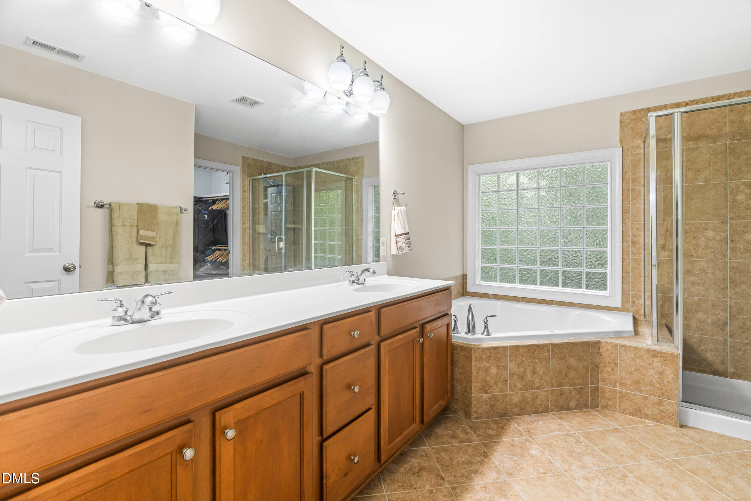 126 Geranium Way Clayton, NC 27527 - Photo 21 of 35 a spacious bathroom with a tub sink and mirror