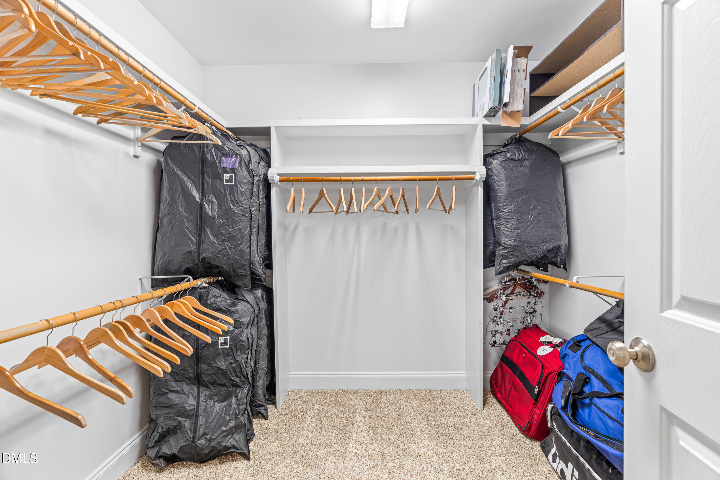 126 Geranium Way Clayton, NC 27527 - Photo 23 of 35 a view of walk in closet with clothes and shoes