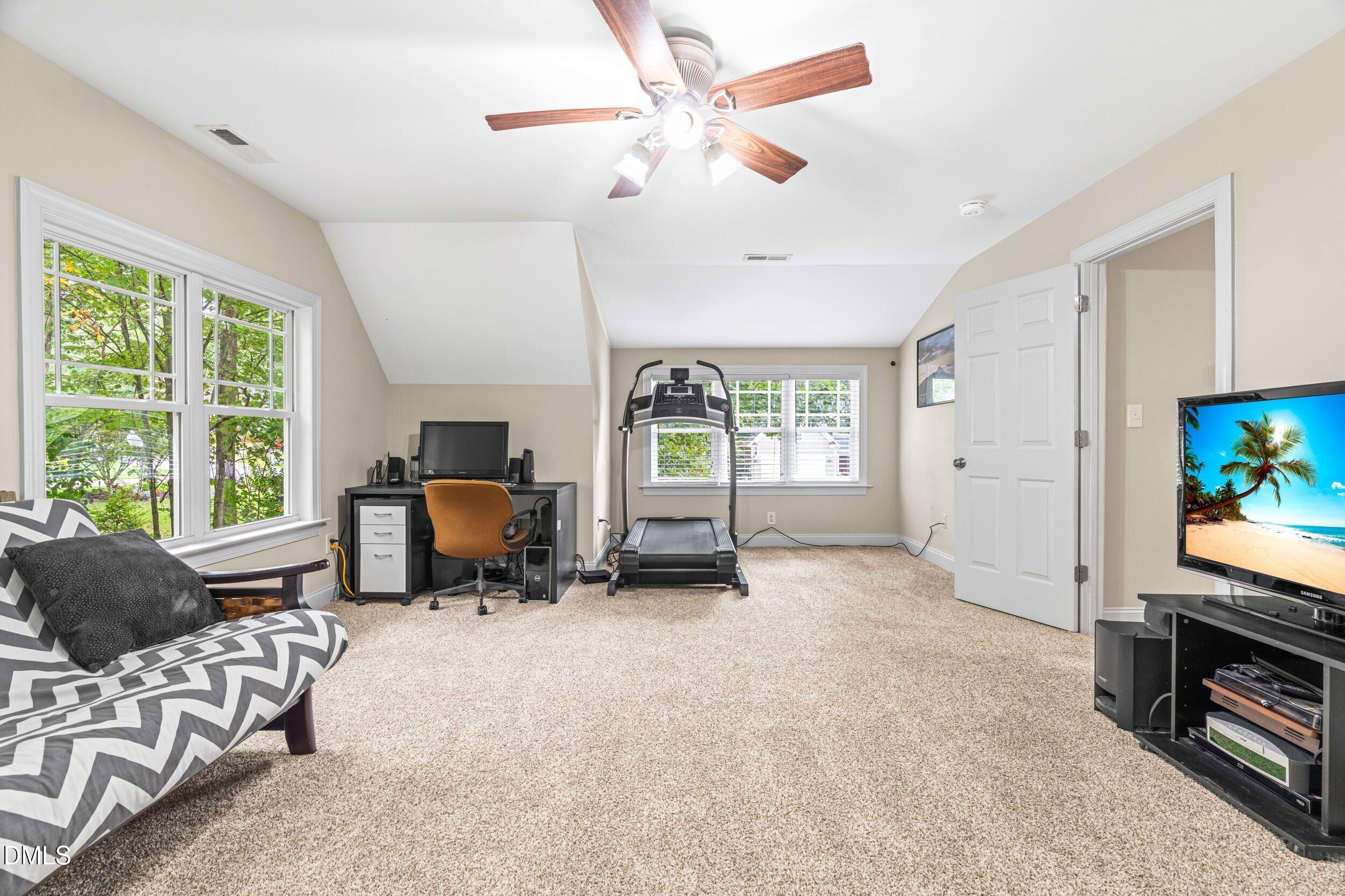 126 Geranium Way Clayton, NC 27527 - Photo 28 of 35 a living room with furniture and a flat screen tv