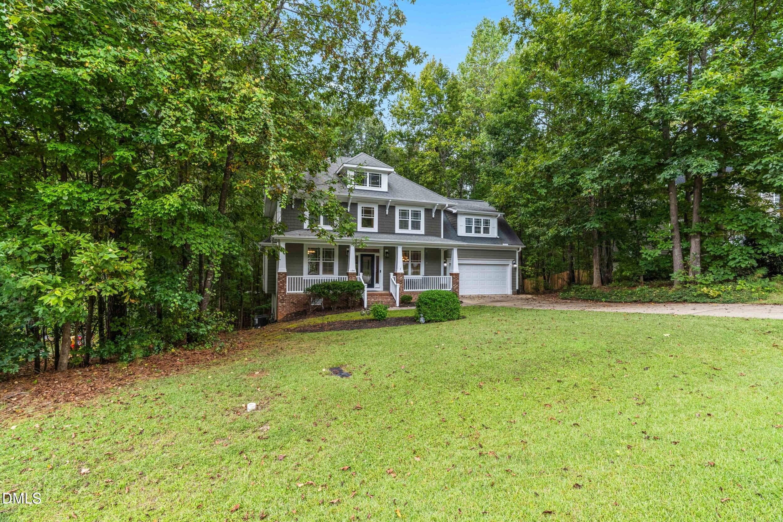 126 Geranium Way Clayton, NC 27527 - Photo 3 of 35 a front view of a house with a garden