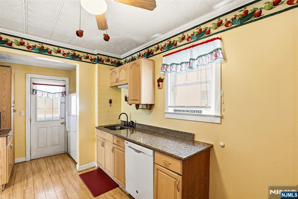332 Riverside Avenue Lyndhurst, NJ 07071 - Photo 18 of 31 a hallway with a sink and a refrigerator