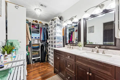 a bathroom with a sink double vanity and a mirror