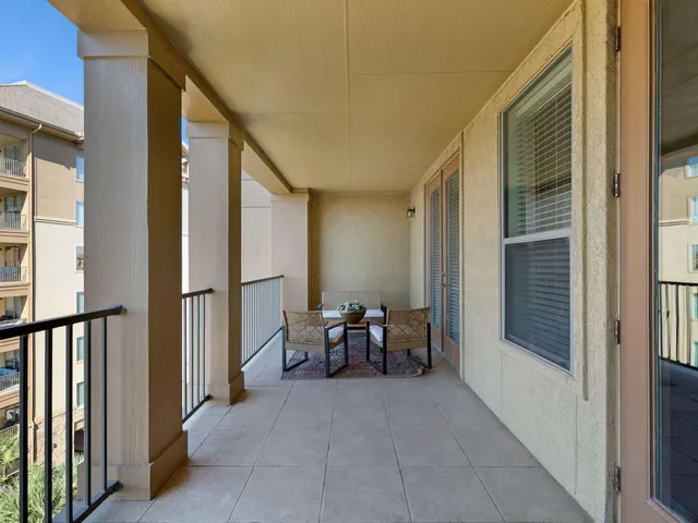 a view of a balcony with chairs