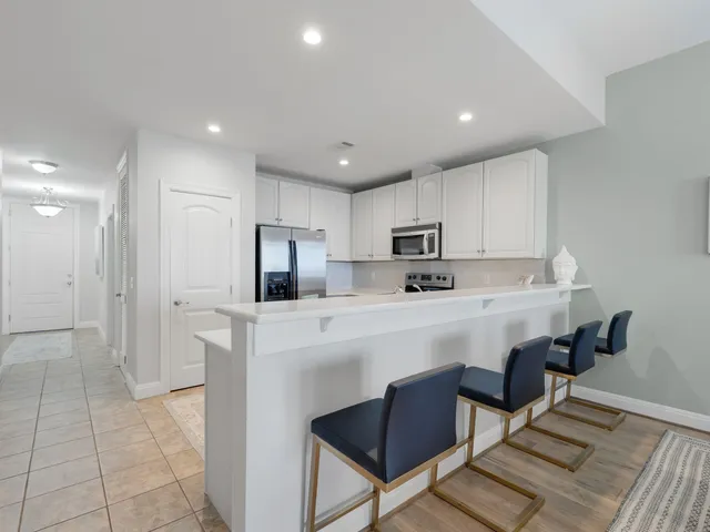 a kitchen with stainless steel appliances a refrigerator and a stove top oven