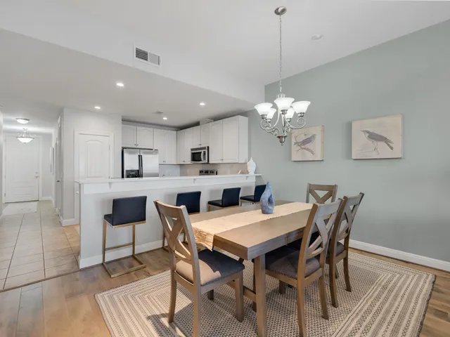 a view of a dining room with furniture and chandelier