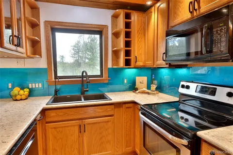 a kitchen that has a sink and a stove