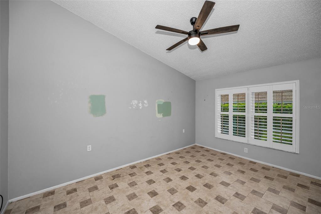 6525 Pine Walk Drive New Port Richey, FL 34655 - Photo 19 of 62 a view of a livingroom with a ceiling fan and window