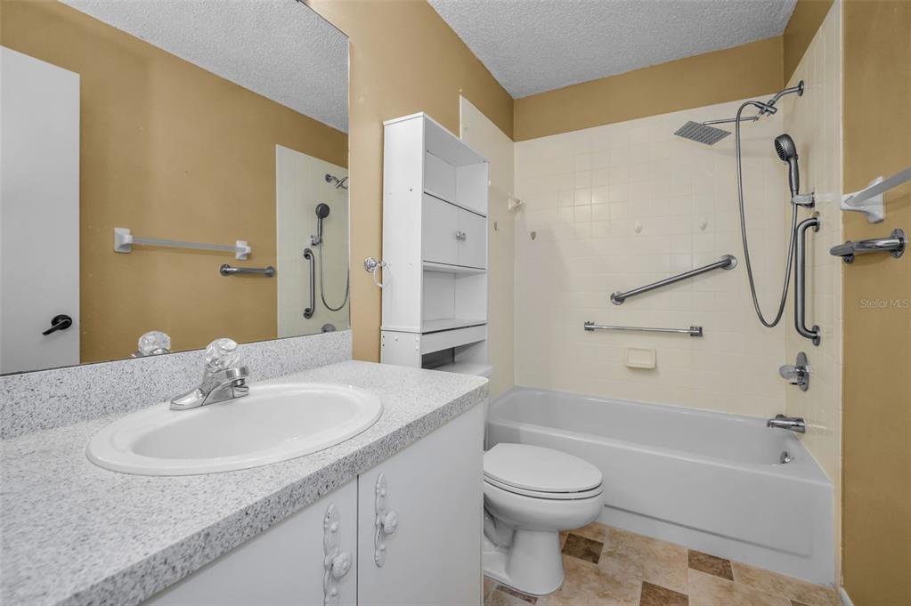 6525 Pine Walk Drive New Port Richey, FL 34655 - Photo 27 of 62 a bathroom with a granite countertop sink toilet and shower