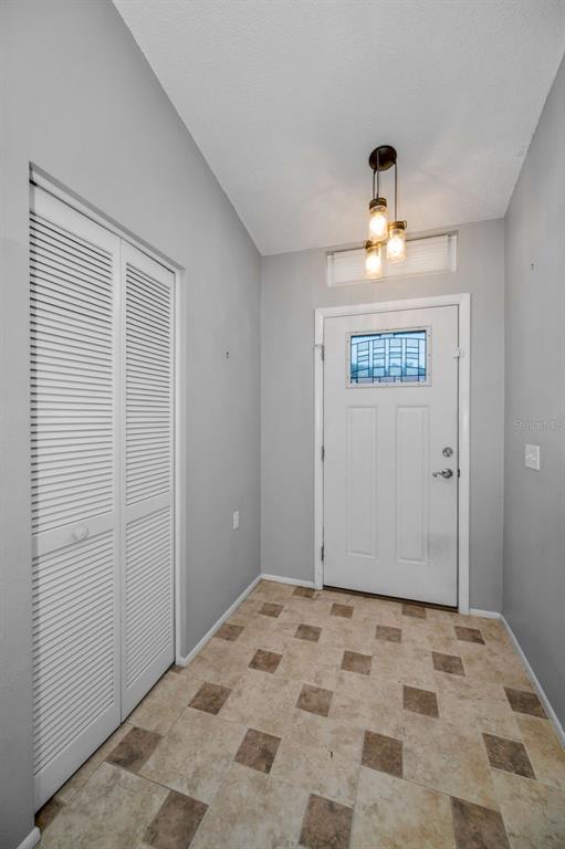 6525 Pine Walk Drive New Port Richey, FL 34655 - Photo 5 of 62 a view of a bedroom with a bed and a window