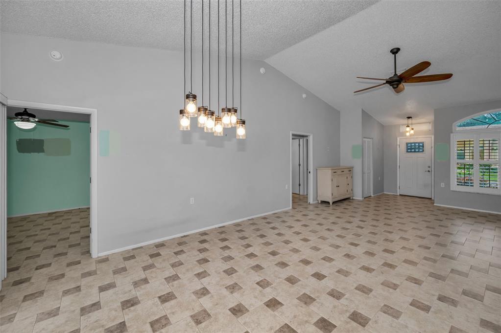 6525 Pine Walk Drive New Port Richey, FL 34655 - Photo 9 of 62 a view of a livingroom with a chandelier fan and windows