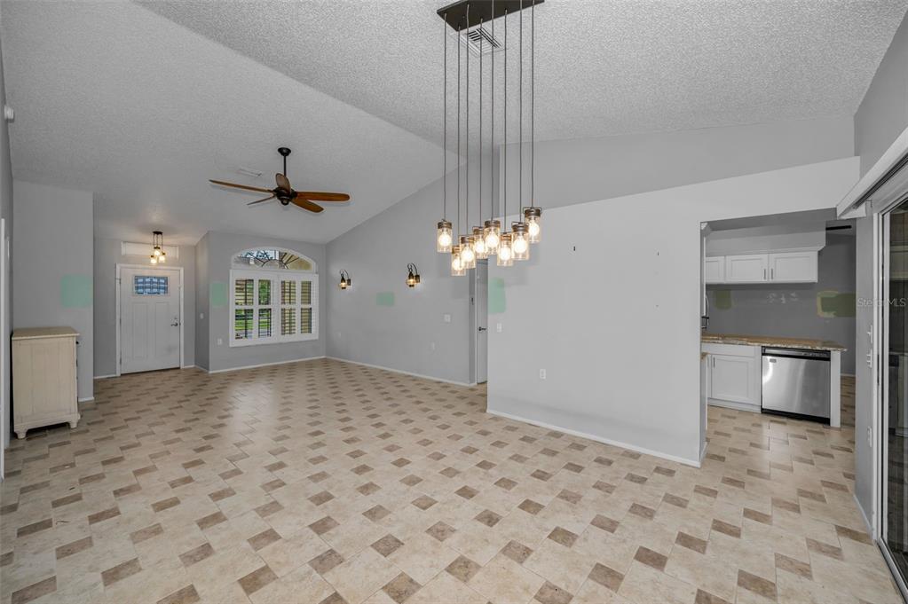 6525 Pine Walk Drive New Port Richey, FL 34655 - Photo 10 of 62 a view of a livingroom with a chandelier furniture and windows