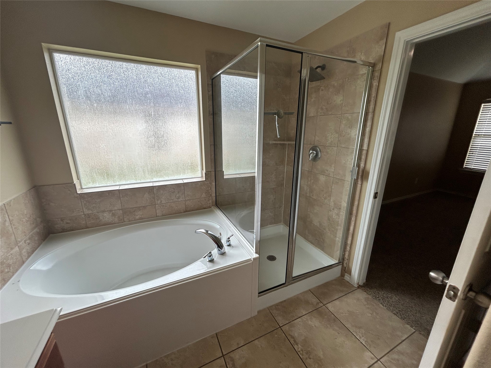 25111 Country Gate Drive Tomball, TX 77375 - Photo 16 of 22 a bathroom with a bathtub and a shower