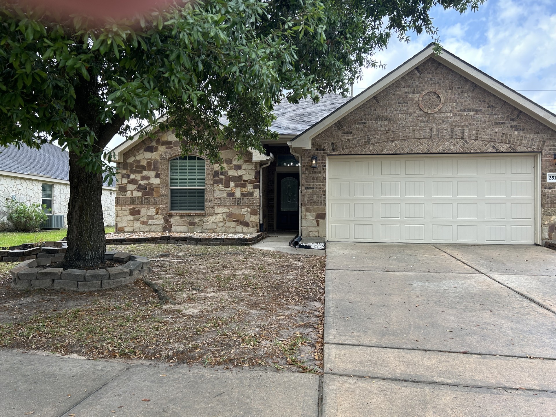 25111 Country Gate Drive Tomball, TX 77375 - Photo 2 of 22 a front view of a house with a yard and garage