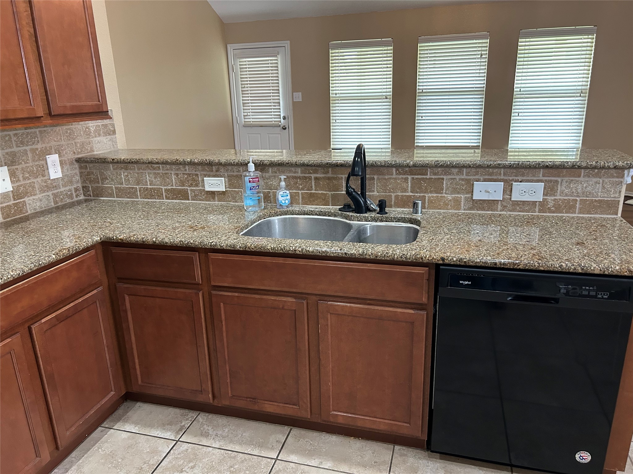 25111 Country Gate Drive Tomball, TX 77375 - Photo 4 of 22 a kitchen with stainless steel appliances granite countertop a sink and a white cabinets