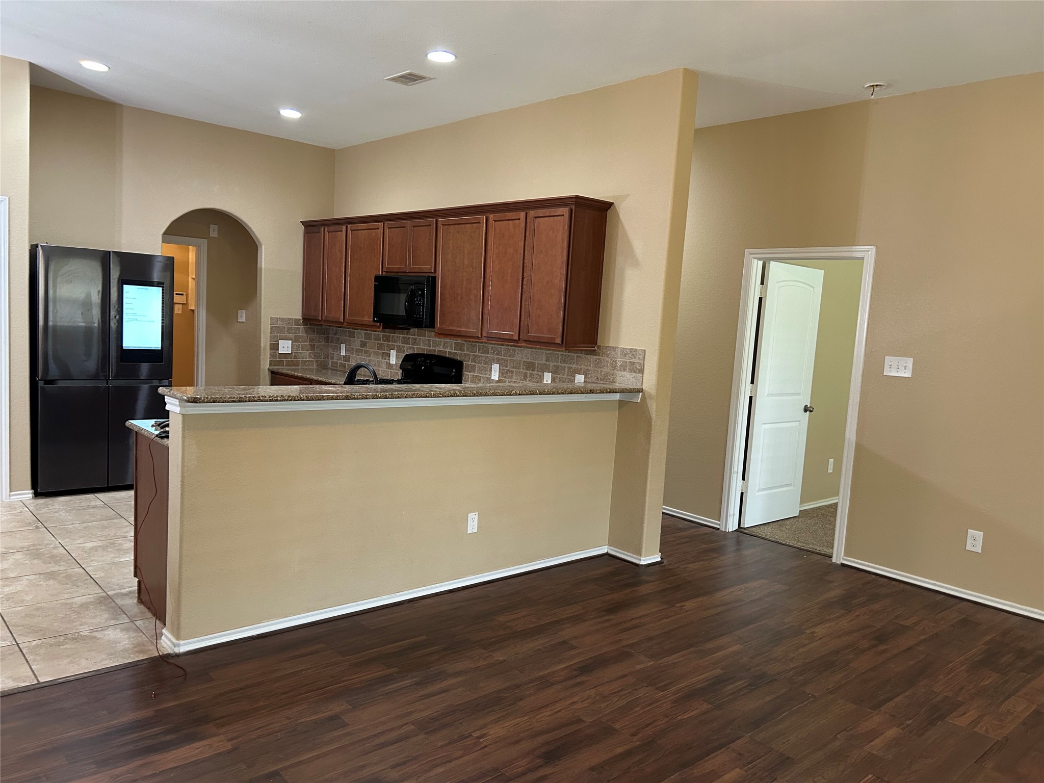 25111 Country Gate Drive Tomball, TX 77375 - Photo 7 of 22 a view of a kitchen with kitchen island wooden floor and center island