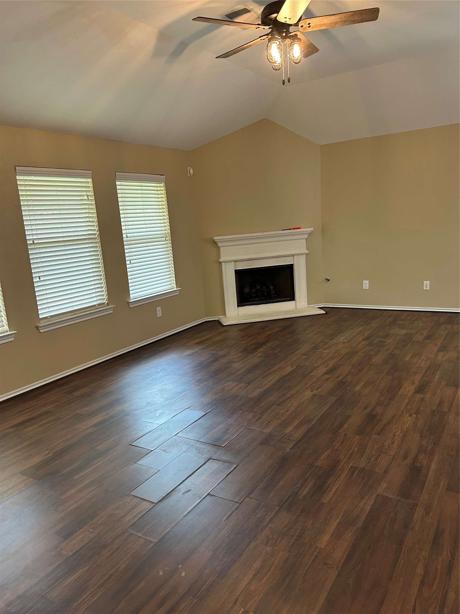 25111 Country Gate Drive Tomball, TX 77375 - Photo 8 of 22 an empty room with wooden floor fireplace and window