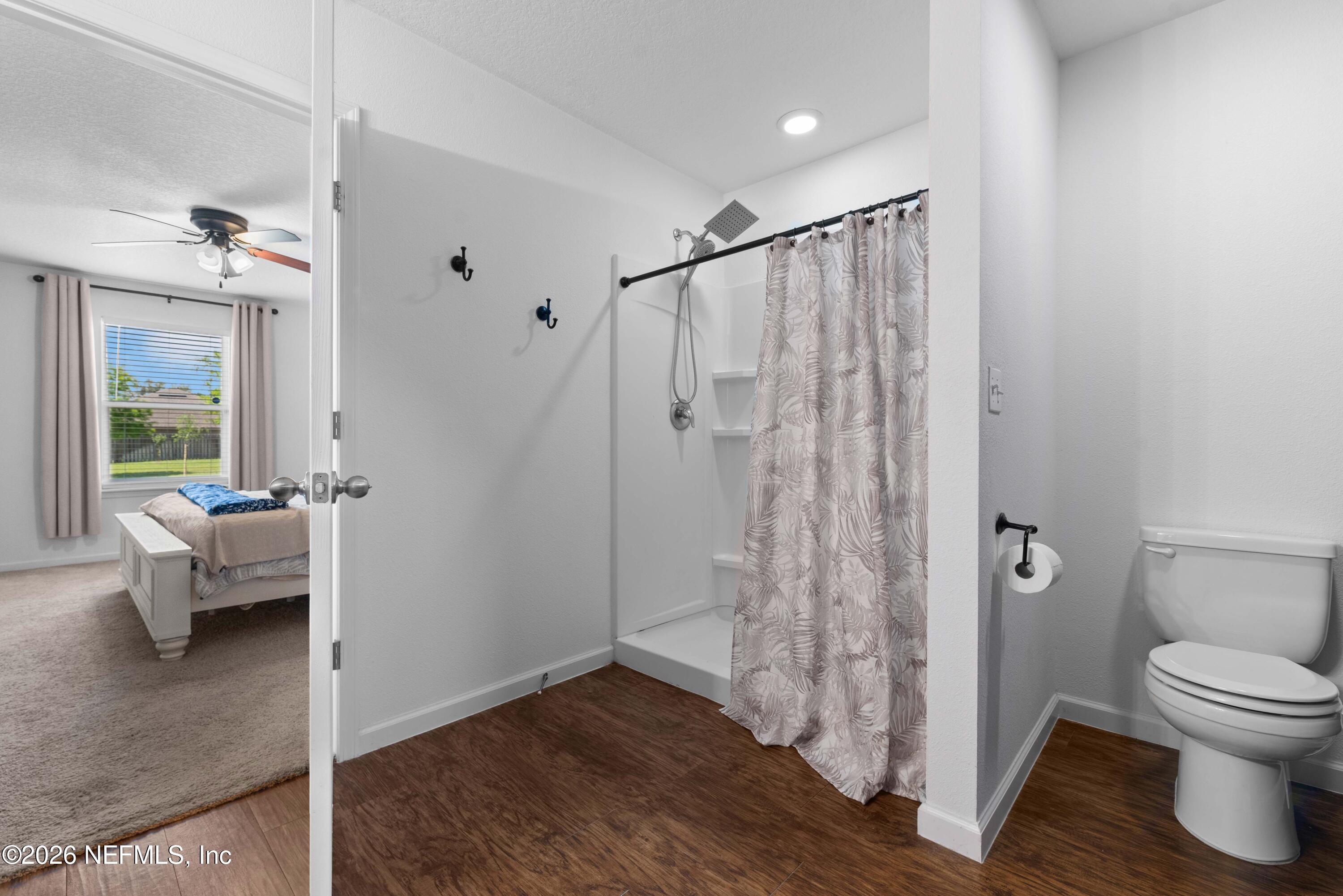 6178 Daylilly Road Macclenny, FL 32063 - Photo 18 of 29 a bathroom with a toilet a sink and a bathtub