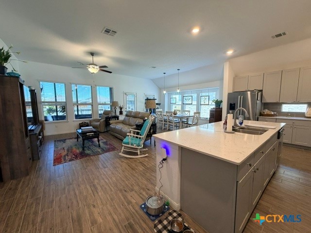 8942 Rancher Place Seguin, TX 78155 - Photo 11 of 48 a kitchen with a sink appliances and wooden floor