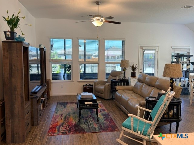 8942 Rancher Place Seguin, TX 78155 - Photo 14 of 48 a living room with furniture a ceiling fan and a flat screen tv