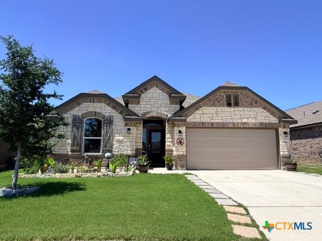 8942 Rancher Place Seguin, TX 78155 - Photo 2 of 48 a front view of a house with a garden and yard