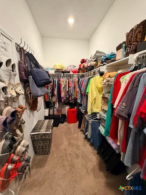 8942 Rancher Place Seguin, TX 78155 - Photo 23 of 48 a view of walk in closet with clothes and shoes