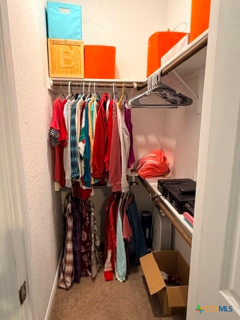 8942 Rancher Place Seguin, TX 78155 - Photo 34 of 48 a view of walk in closet with clothes and shoes