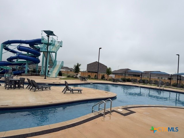 8942 Rancher Place Seguin, TX 78155 - Photo 44 of 48 a view of a swimming pool with a table and chairs