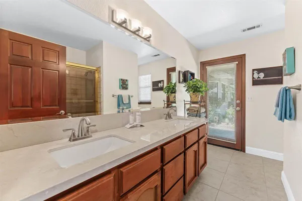 a bathroom with a sink double vanity and a mirror