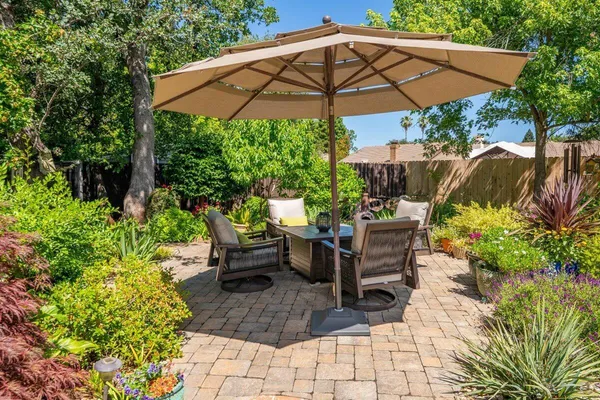 a view of a chair and table in the patio