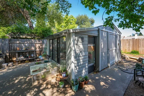 a view of a backyard with plants and a patio