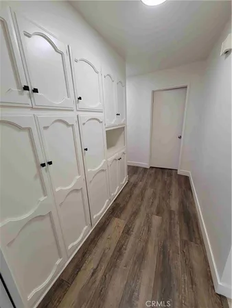 a view of a room with wooden floor