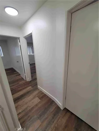 an entryway in a hall with wooden floor