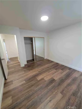 a view of an empty room and wooden floor