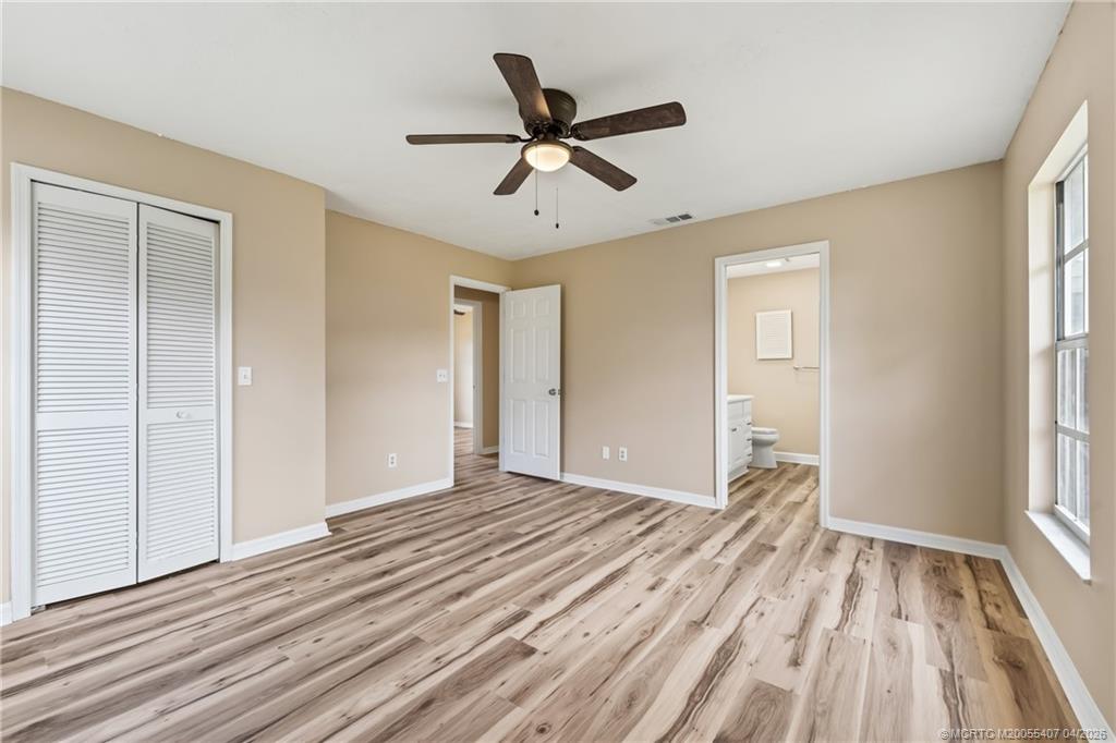 6285 Southeast Highland Avenue Stuart, FL 34997 - Photo 13 of 24 a view of empty room with wooden floor and fan