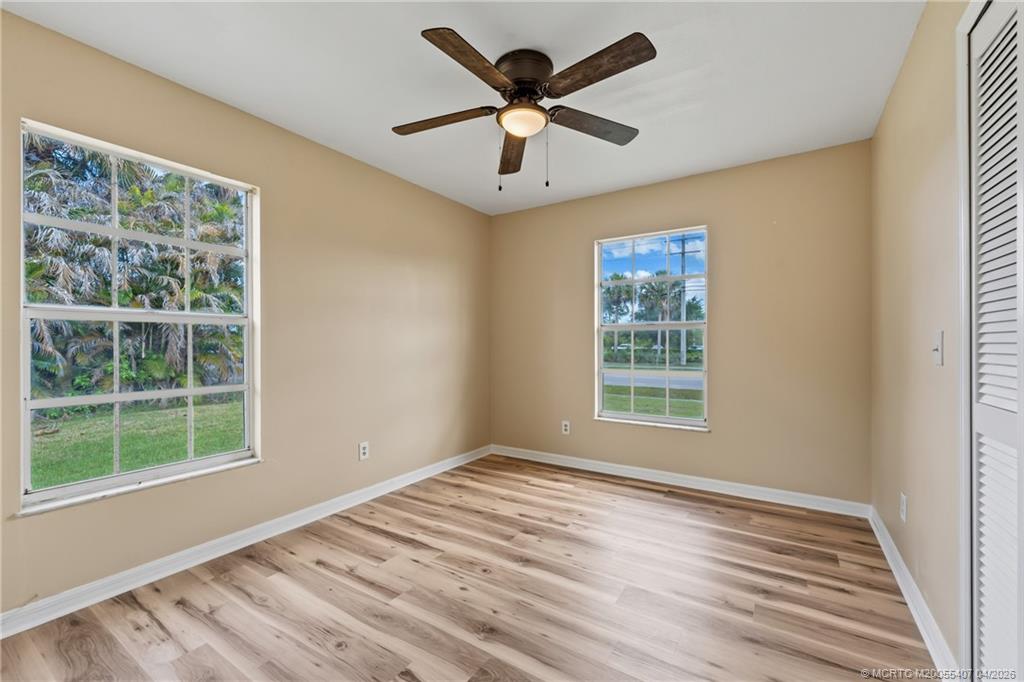 6285 Southeast Highland Avenue Stuart, FL 34997 - Photo 16 of 24 a view of empty room with wooden floor and fan