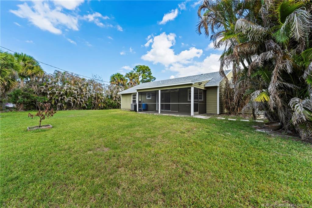 6285 Southeast Highland Avenue Stuart, FL 34997 - Photo 4 of 24 a view of a house with a backyard