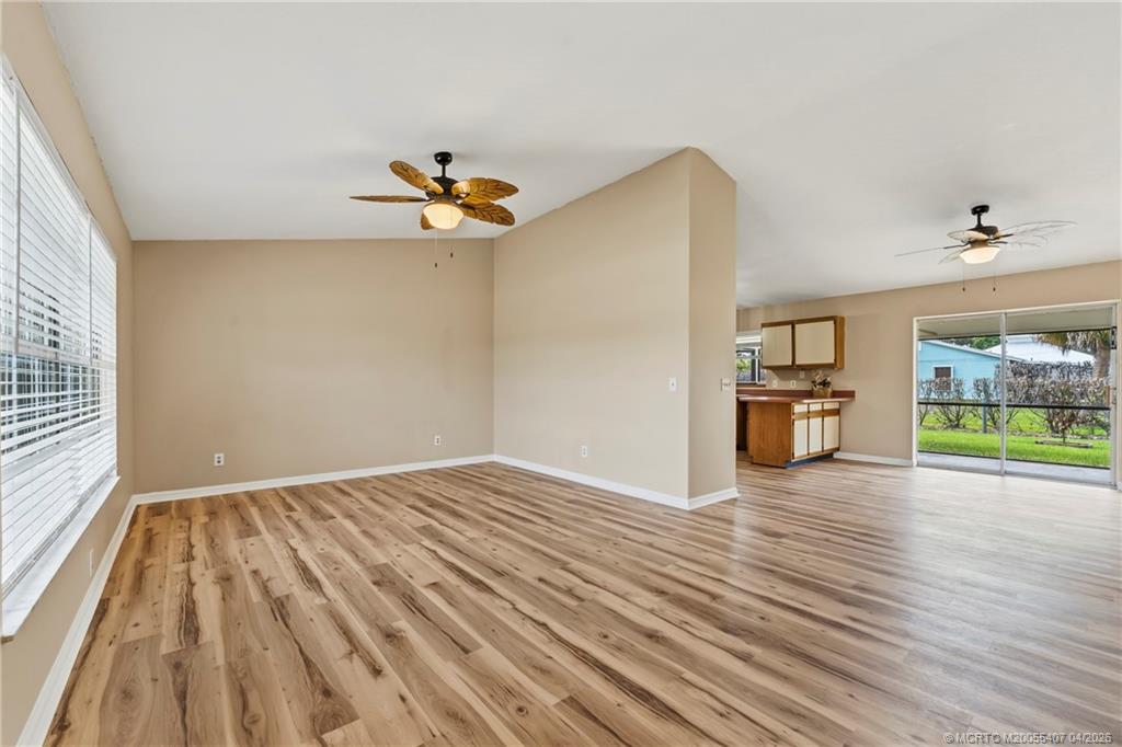 6285 Southeast Highland Avenue Stuart, FL 34997 - Photo 8 of 24 wooden floor in an empty room with a window