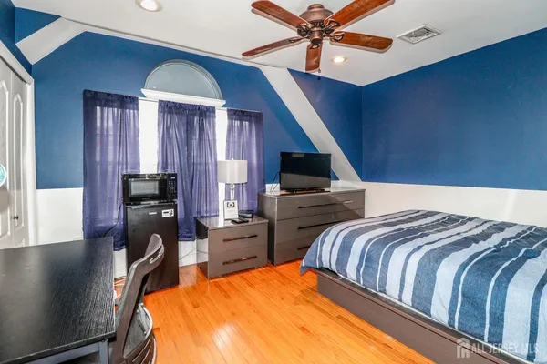 a bedroom with a bed and a chandelier