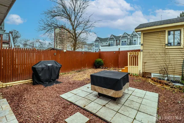 a view of a patio with table and chairs with wooden floor and fence