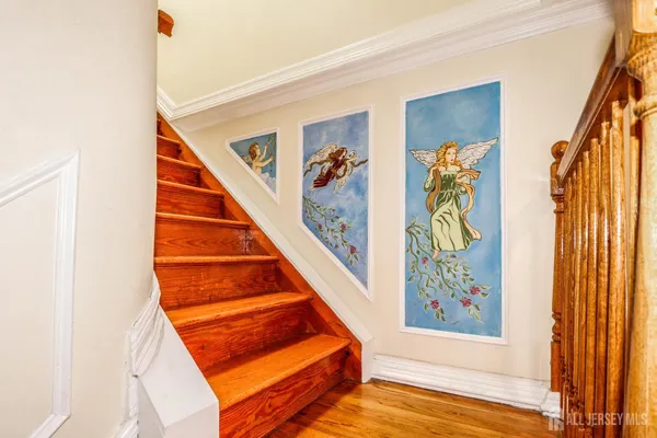 a view of an entryway with wooden floor