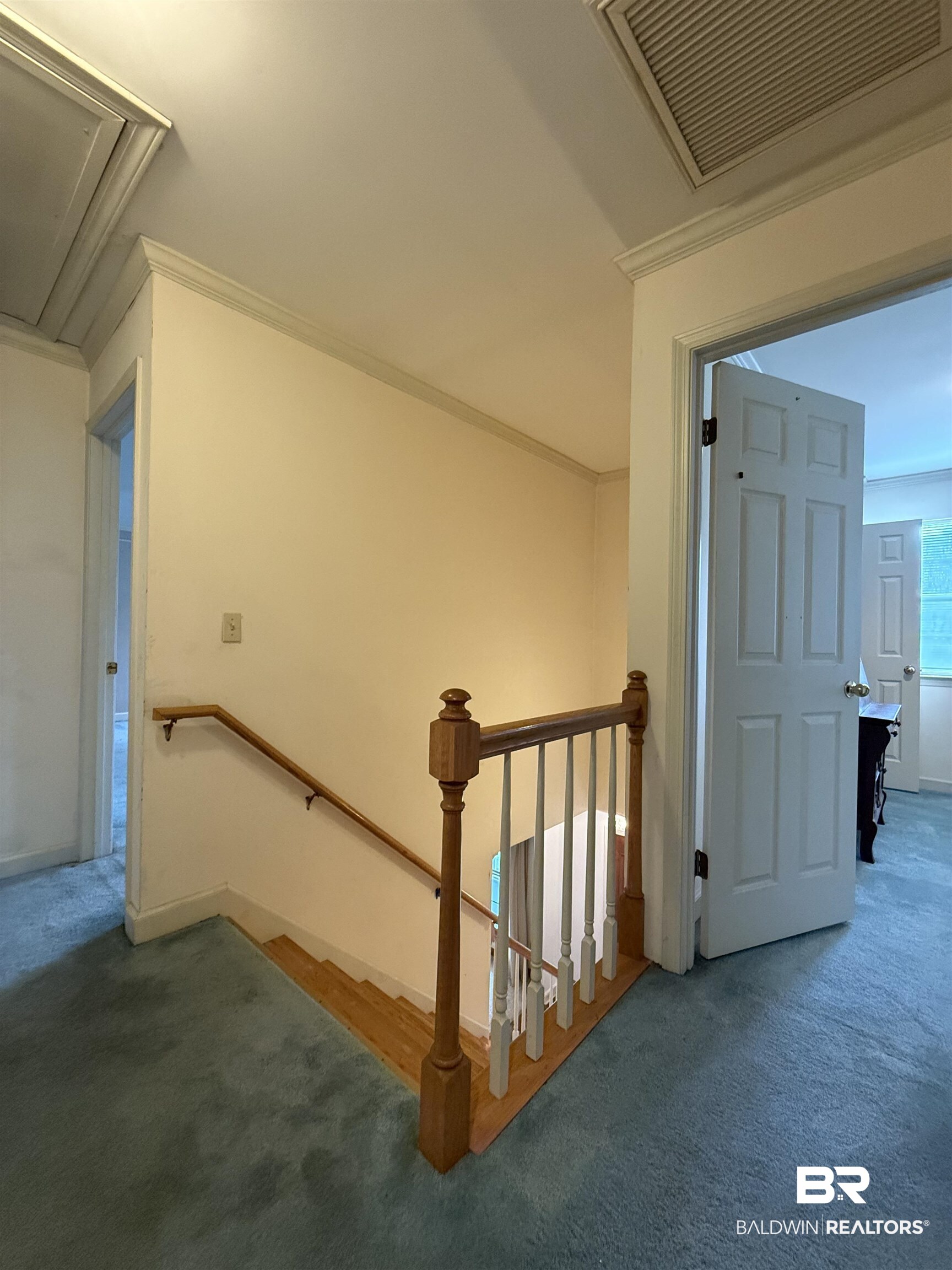 295 Norwood Road Monroeville, AL 36460 - Photo 26 of 32 Staircase with attic access, carpet floors, ornamental molding, and baseboards