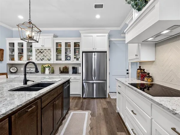 a kitchen with a sink stove and refrigerator