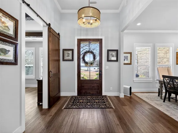 a view of an entryway with wooden floor