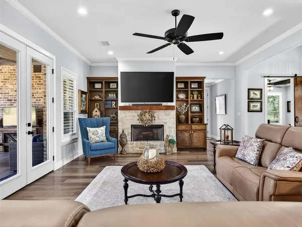 a living room with furniture a fireplace and a flat screen tv