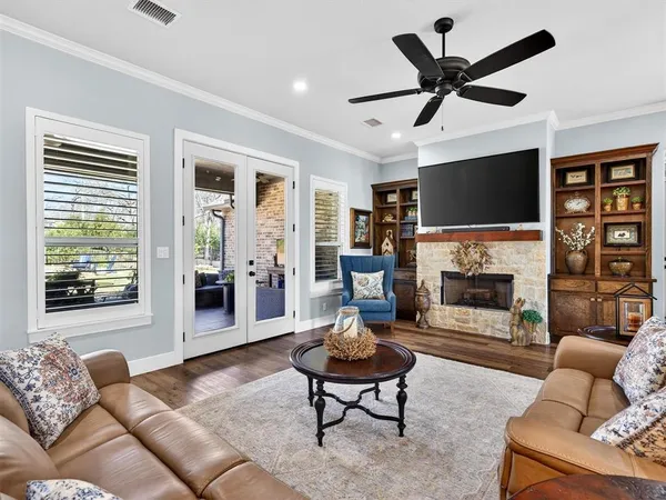 a living room with furniture a fireplace and a flat screen tv