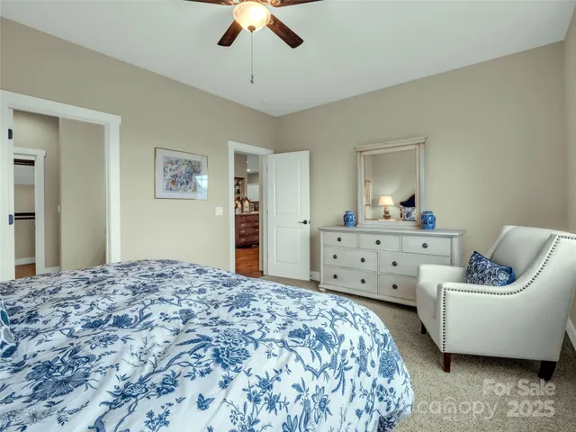 a spacious bedroom with a bed and a chandelier