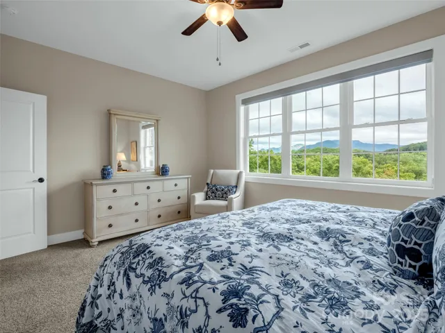 a spacious bedroom with a large bed and a window