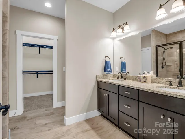a bathroom with a double vanity sink and a mirror